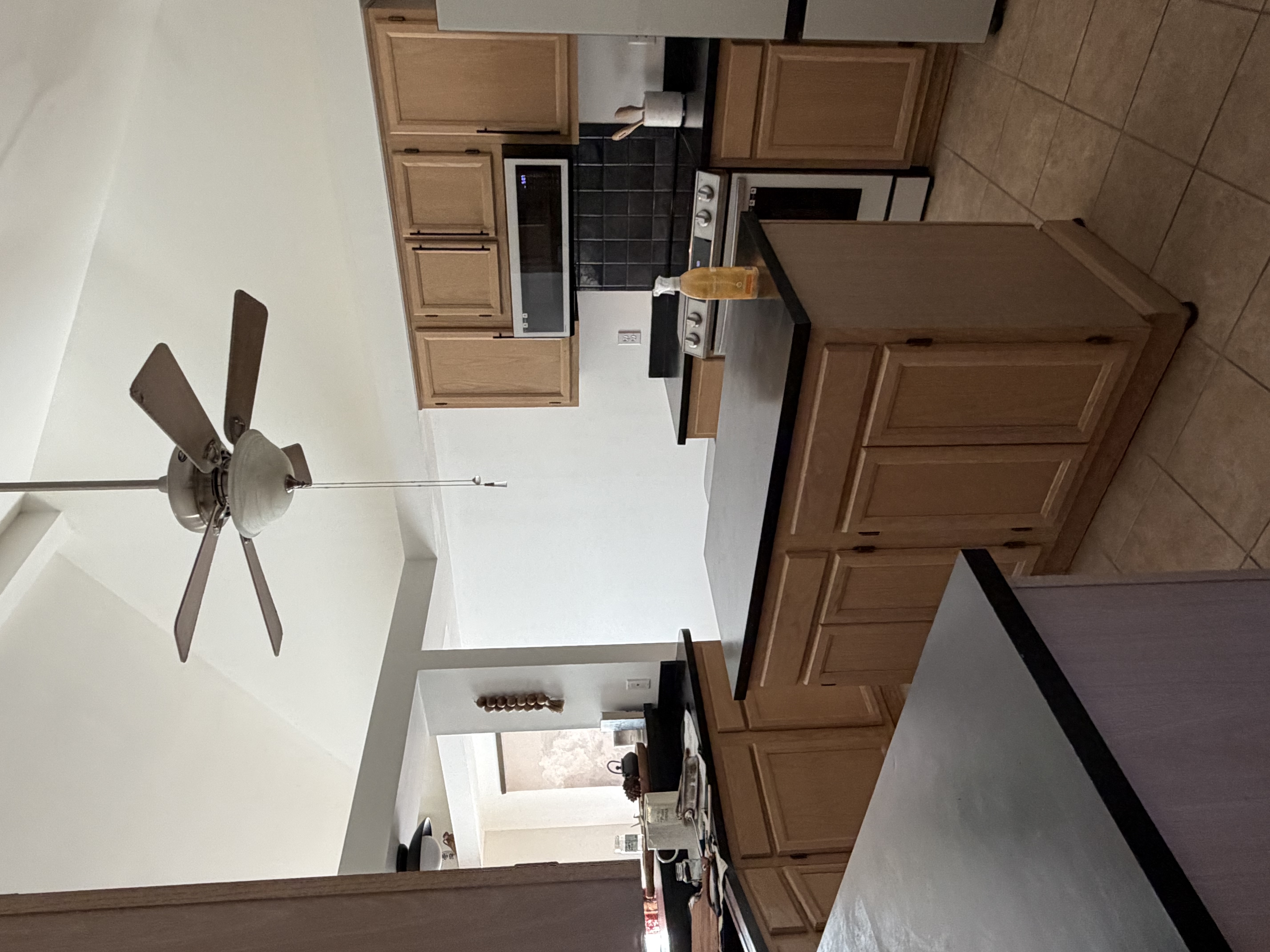 Kitchen with modern appliances, clean surfaces, and natural lighting