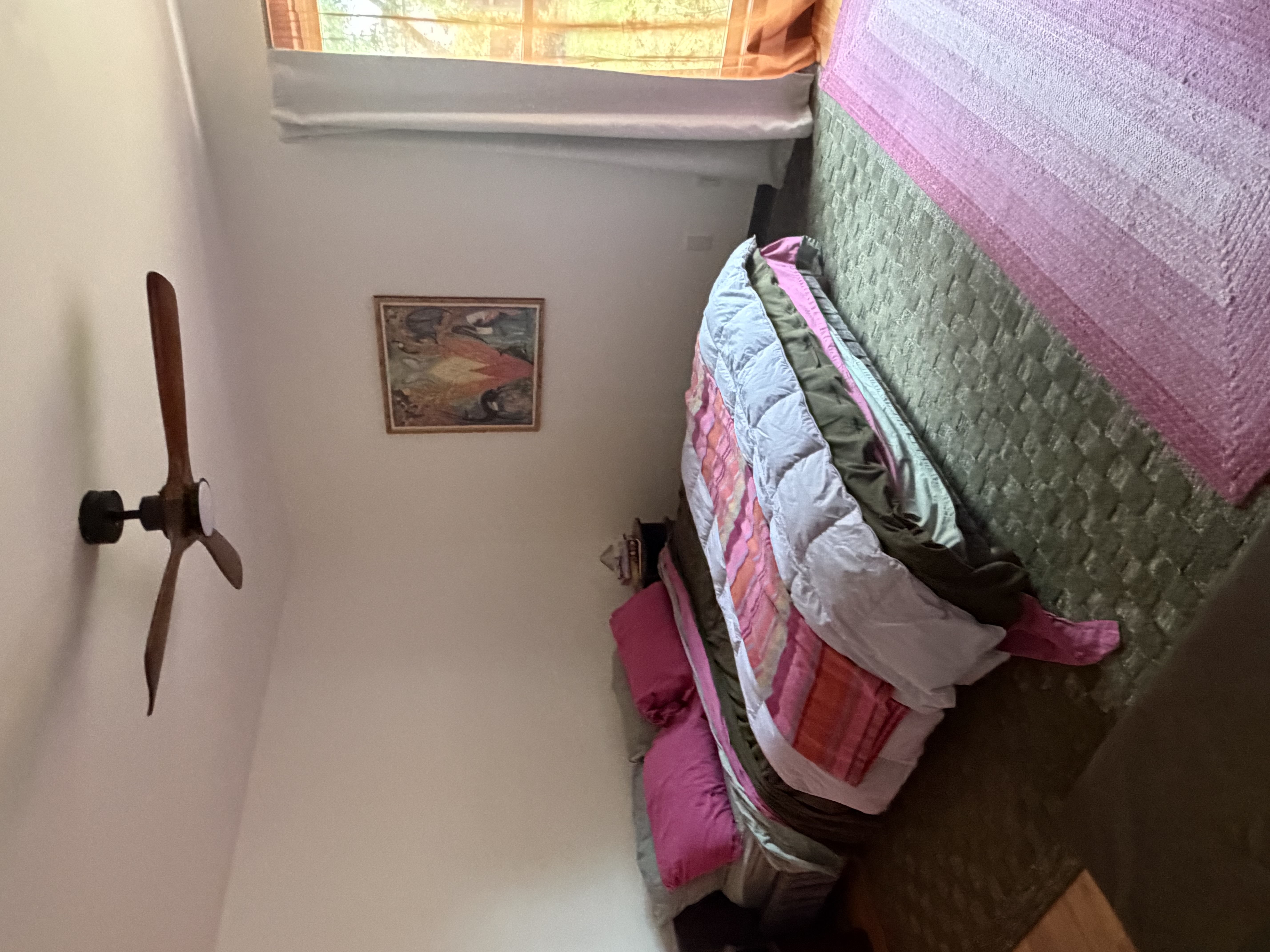 Main bedroom featuring wool area rugs, soft cotton linens, and warm natural lighting
