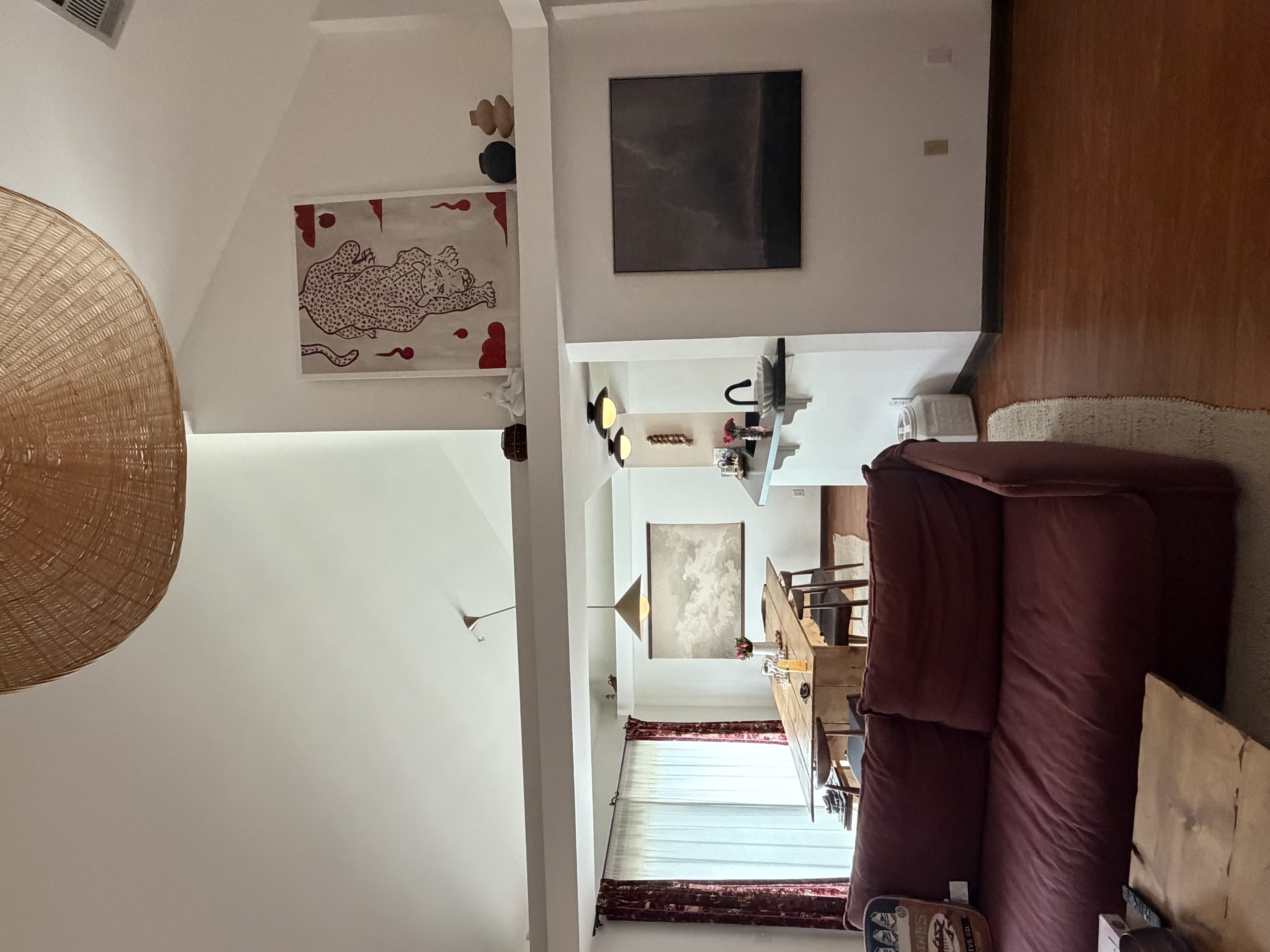 Living room with beautiful artwork, organic cotton textiles, and a plush goose-down sofa