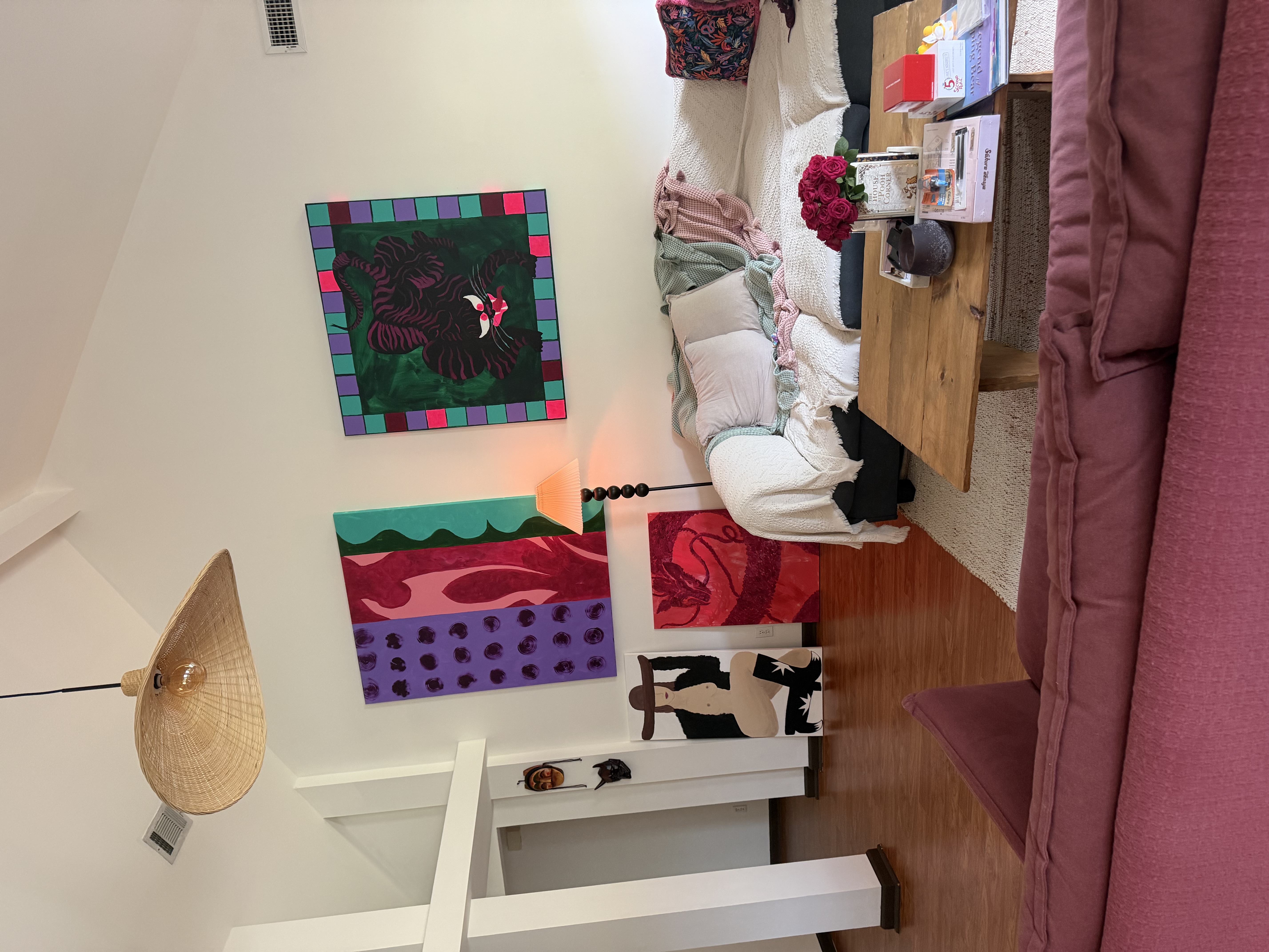 Bright living space with unique artwork, high ceilings, and an open, airy feel